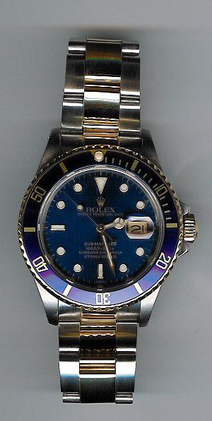 Rolex. Submariner. Gold and steel. Sapphire crystal. Blue dial.